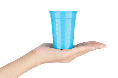 Hand holding Blue plastic glass isolated on white backgroundの写真素材