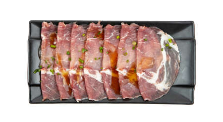 sliced collar pork raw with sauce isolated on white backgroundの写真素材