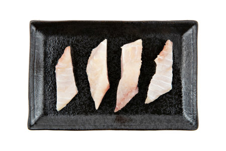 Fresh dolly fish fillet sliced on plate isolated on white background.