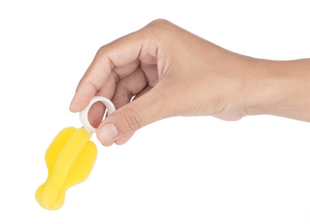 Hand holding Sponge for Clean nipple isolated on white backgroundの写真素材