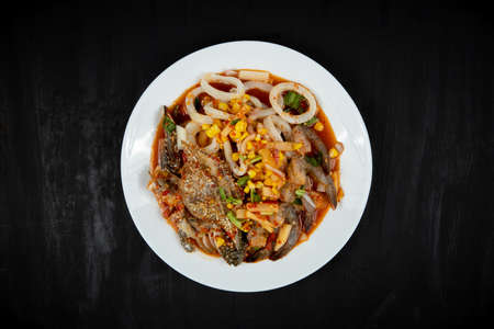 spicy mixed seafood on plate wood background.の写真素材