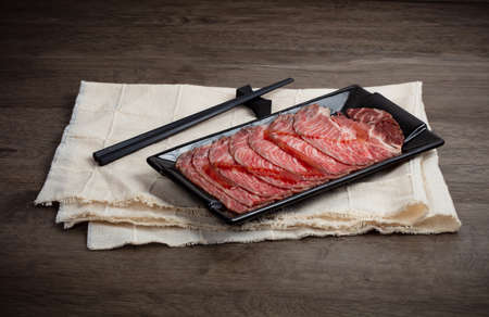 Set of raw meat beef slice in plate on wood background