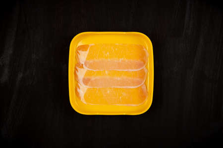 meat slice in tray on black backgroundの写真素材