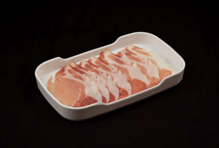 meat slice in tray on black backgroundの写真素材