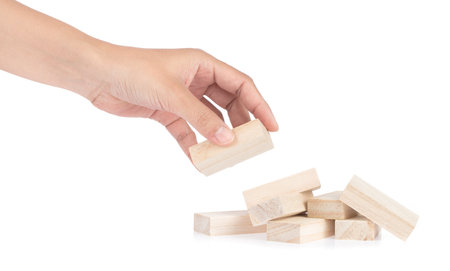 Hand holding wooden block isolated on white backgroundの写真素材