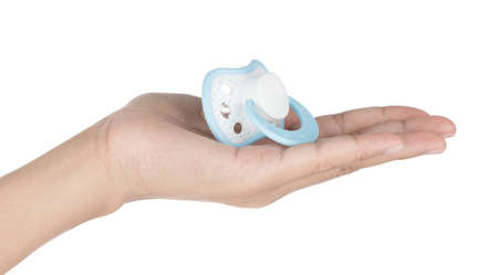 Hand holding silicone baby soothers isolated on a white background
