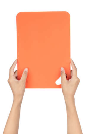 Hand holding Plastic cutting board isolated on white background.の写真素材