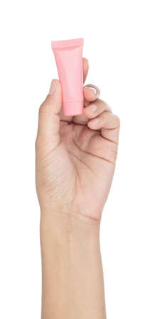 Hand holding Empty Plastic Beauty Portable Cream Container Lotion Travel Isolated on White Backgroundの写真素材