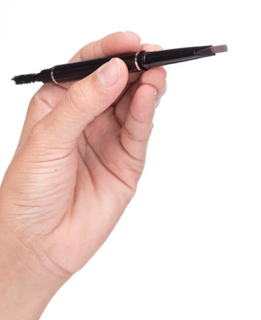 Hand holding Eyebrow pencil isolated on white  âbackgroundの写真素材