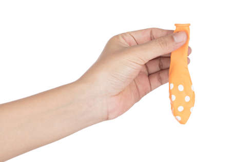 hand holding Deflated balloon isolated on white backgroundの写真素材