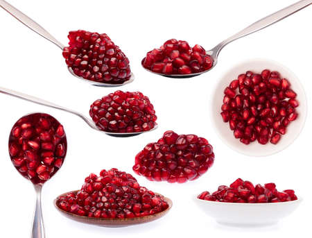 Set of Pomegranate seed on spoon isolated on white background.の写真素材
