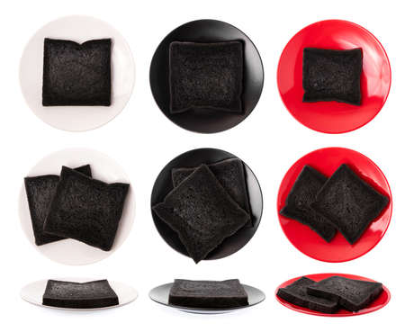 Collection of charcoal bread on plate isolated on white background.の写真素材