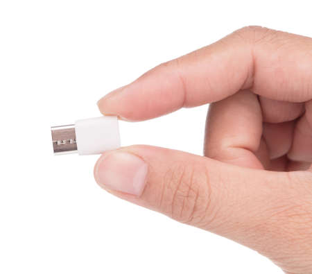 Hand holding Micro USB to USB-C adapter isolated on white backgroundの写真素材