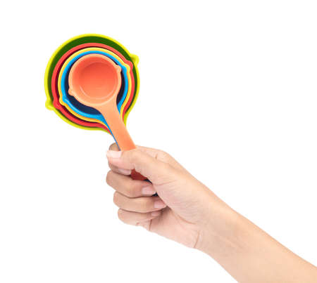 hand holding set of plastic scoop utensil  isolated on white backgroundの写真素材