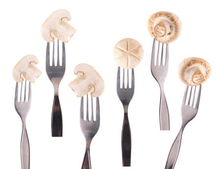 Collection of Champignon Mushroom on fork isolated on white background
