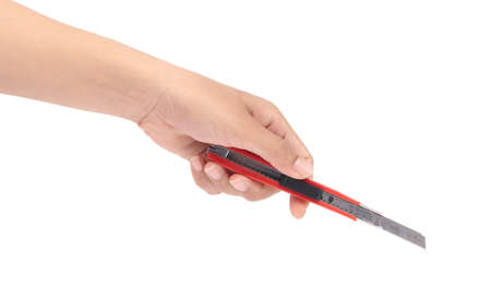 hand holding Red cutter knife isolated on white background