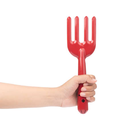 hand holding Red Garden rake isolated on white background