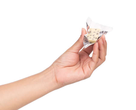 hand holding white chocolate bars isolated on white backgroundの写真素材