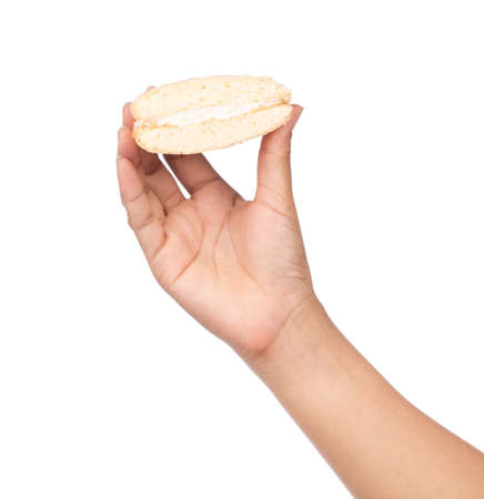 hand holding Vanilla cream biscuits isolated on white background.の写真素材