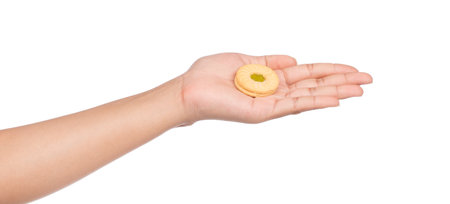 hand holding cookie with jam kiwi isolated on white background.の写真素材