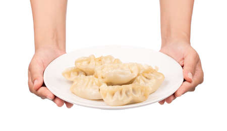hand holding wontons on dish isolated on white background.の写真素材