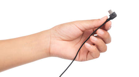 hand holding audio jack 3.5mm to split mic and headphone sockets converter cable isolated on white backgroundの写真素材