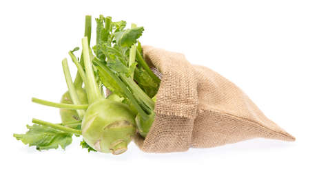 Fresh kohlrabi in burlap bag isolated on white backgroundの写真素材