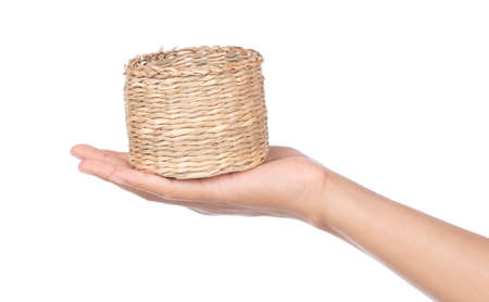 hand holding wicker basket isolated on white backgroundの写真素材