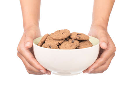 hand holding bowl of chocolate chip cookie isolated on white backgroundの写真素材