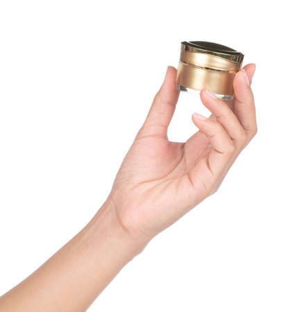 hand holding cosmetic face cream isolated on white background.の写真素材