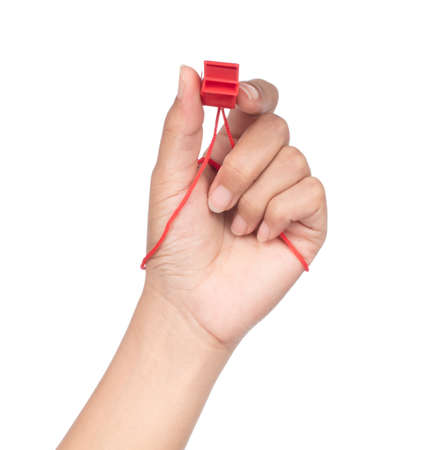 hand holding sport whistle isolated on white backgroundの写真素材