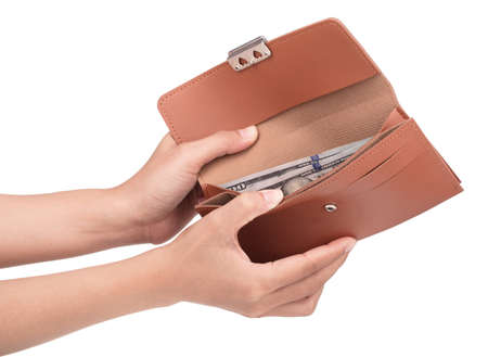 Hand holding Brown leather purse isolated on white background.