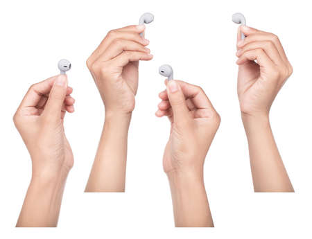 Set of Hand holding Grey wireless headphones isolated on a white background.
