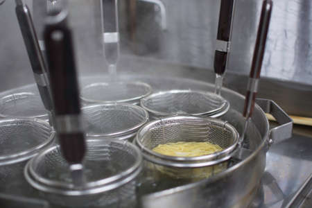 Boiling Japanese ramen noodles at a restaurant kitchenの写真素材