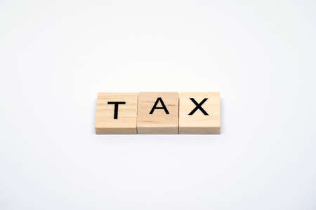 "TAX" Wooden letters on white backgroundの写真素材