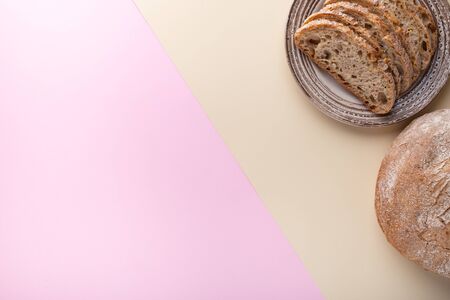 Flat lay with bread on a two-color surface. Colorful template with place for text.