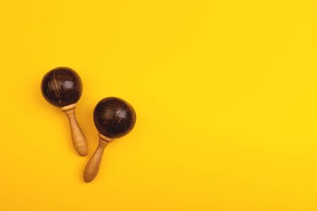 Two mexican maracas isolated on yellow background. Traditional folk musical instruments. Elements of national culture. Flat lay. Latin music.の写真素材