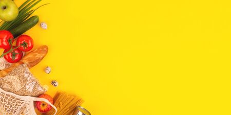 Food packaging on yellow background. Quarantine food delivery home. Flatlay banner with copyspace.