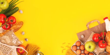 Food packaging on yellow background. Quarantine food delivery home. Flatlay banner with copyspace.