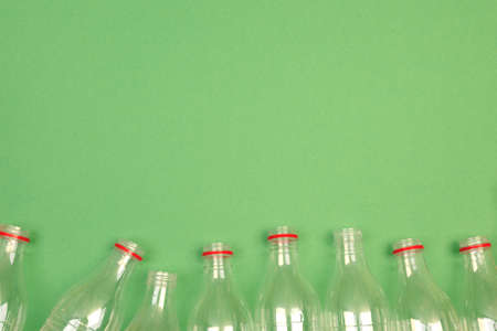 Empty plastic PET bottles on a green background. Waste sorting, environmental care. Copyspace.の写真素材