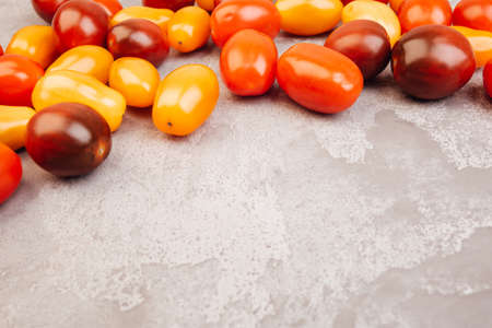 Cherry tomatoes on gray marble background. Copyspace.の写真素材