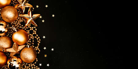 Christmas and New Year banner with copy space. Golden balls and stars on black backdrop.の写真素材