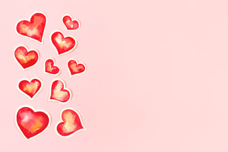 Composition with red watercolor paper hearts. Background with copy space for Valentine's Day.の写真素材