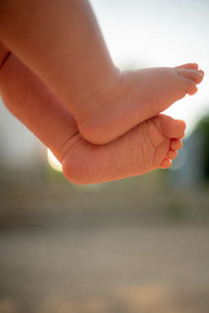 baby legs, feets 6 month baby, lens flaireの写真素材