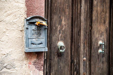 Rusty Letterbox next to door, Italyの写真素材