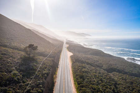 Aerial View Drone Shot of Highway Pacific Coast Highway California USA Big Sur Mountains Ocean Fogの写真素材