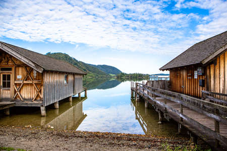 Scenic seaside of lake Schliersee on a sunny day with blue sky in Bavaria, Germany. Cottage