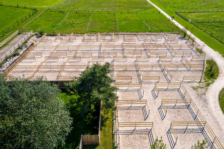 Outdoor boxes paddocks for horses on a farm. Wood fences. Aerial Drone Photoの写真素材