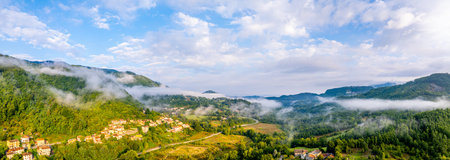 Tuscany Morning Atmosphere with fog and mist. Beautiful Aerial Panoramaの写真素材