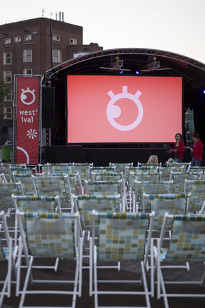 Amsterdam, The Netherlands, 12-14 September 2014, during Westival, an open air free Cinema and culture festival on Mercatorplein. before the screening, preparation, people hanging around and children playingのeditorial素材